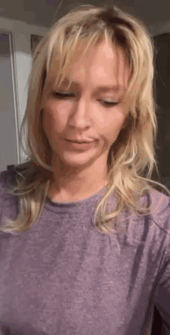 Blonde Woman in Purple Shirt Looking Down