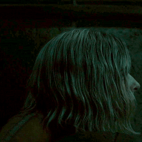 Blonde Woman Looking at Camera in Dark Room