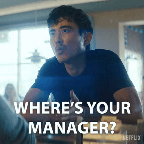 Blonde Woman Saying Because I'm The Manager In Front Of Shelf GIF