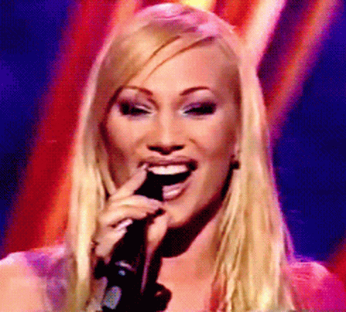 Blonde Woman Singing and Smiling