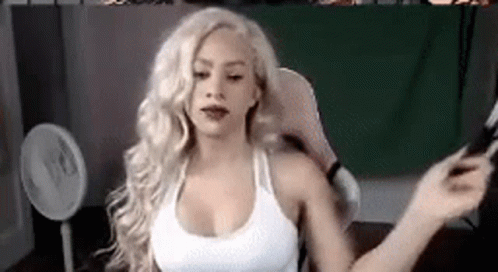 Blonde Woman Sitting in Chair with Fan