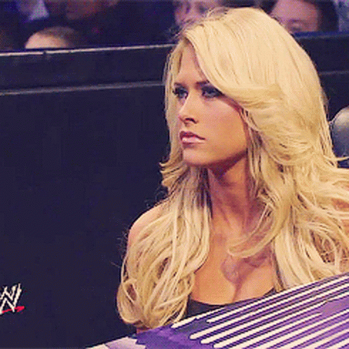 Blonde Woman Sitting in Front of Wrestling Ring