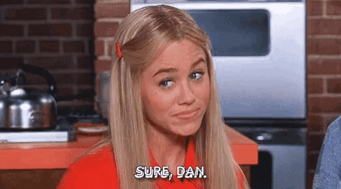 Blonde Woman Sitting in Kitchen Talking