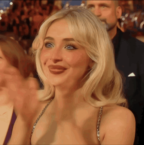 Blonde Woman Smiling in Crowd