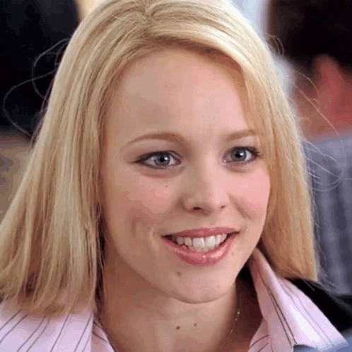 Blonde Woman Smiling in Pink Shirt