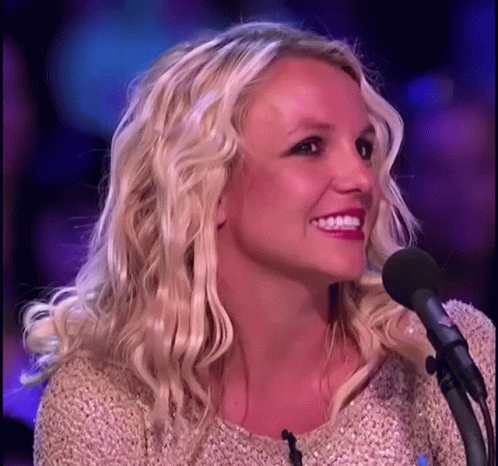 Blonde Woman Smiling Into Microphone