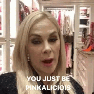 Blonde Woman Standing In Front Of Closet Talking To Camera GIF