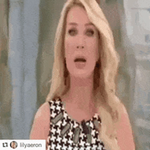 Blonde Woman Surprised in Black-and-White Dress