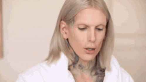Blonde Woman With Tattoo In White Coat GIF