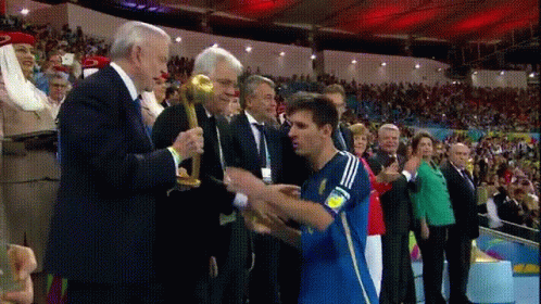 Blue Adidas Jersey Man Receiving Trophy From Suited Man GIF