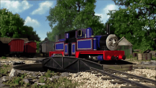 Blue and Red Smiling Train on Track
