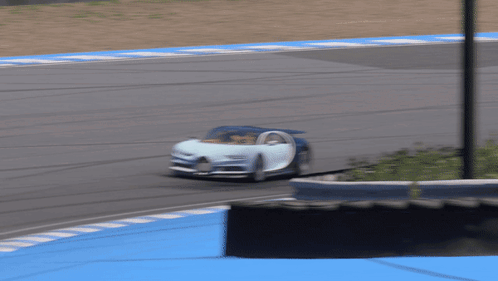Blue and White Car Driving on Track
