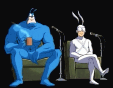 Blue and White Cartoon Characters Sitting at Microphones