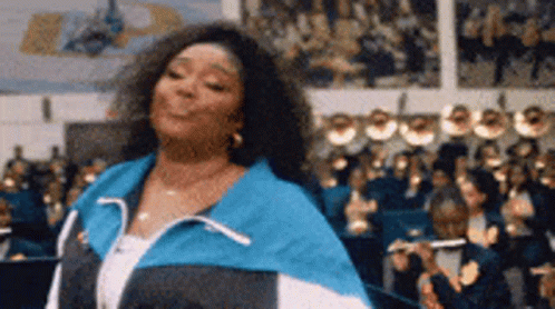 Blue and White Jacket Woman Dancing Before Crowd