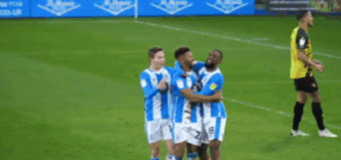 Blue and White Striped Soccer Players Celebrating Goal