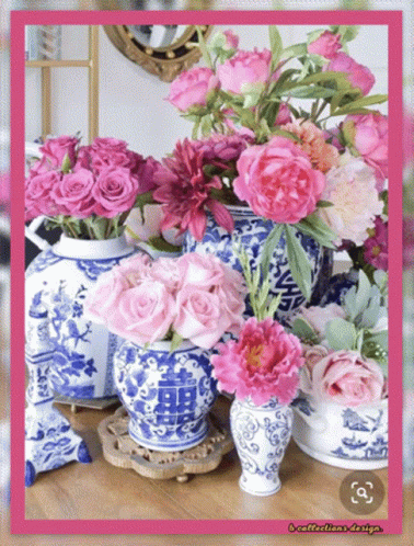 Blue And White Vases Filled With Pink Flowers With A Pink Frame GIF
