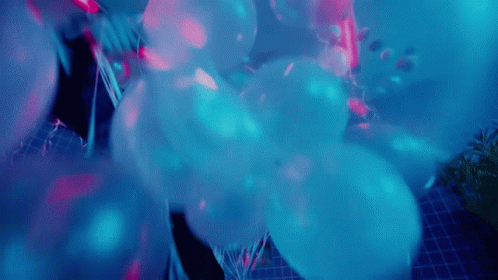 Blue Balloons Floating in Dark Room