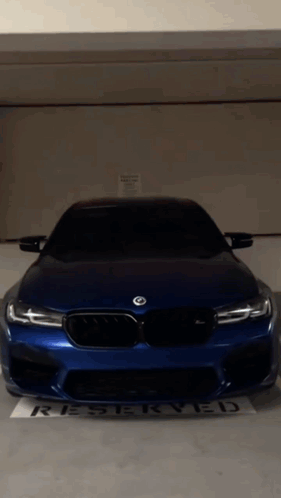 Blue BMW Parked in Reserved Parking Lot