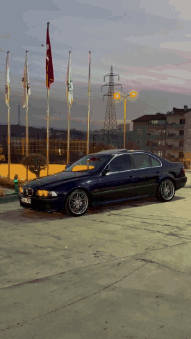 Blue BMW Parked With Flags
