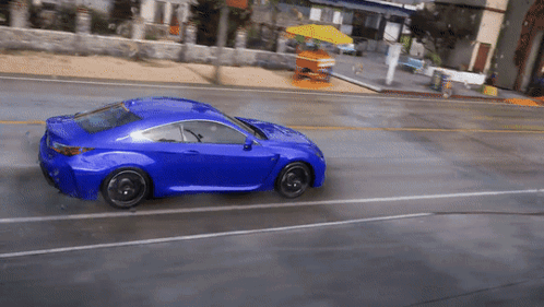 Blue Car Driving in Rain