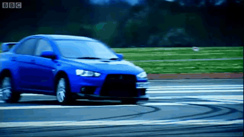 Blue Car Driving on Road With BBC Logo