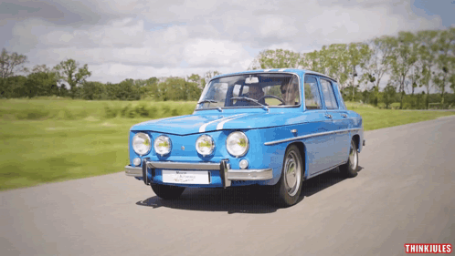 Blue Car Driving With Thinkiules Logo