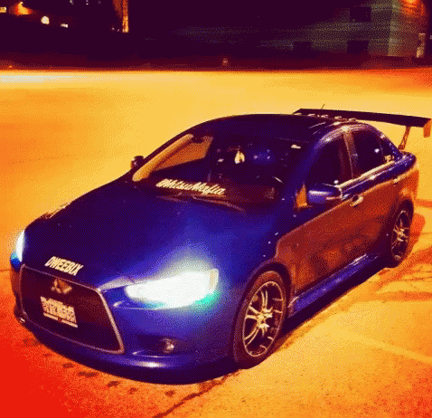 Blue Car With Mitsubishi Sticker
