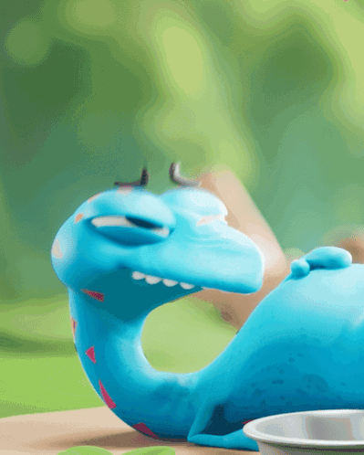 Blue Dinosaur Lying Next to Food Bowl