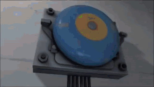 Blue Disc Yellow Center On Metal GIF
