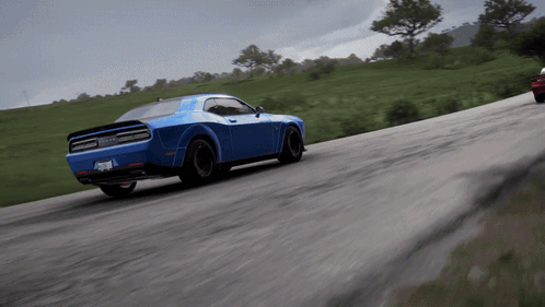 Blue Dodge Challenger Driving Next to Red Car