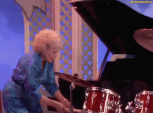 Blue Dress Woman Drumming by Grand Piano