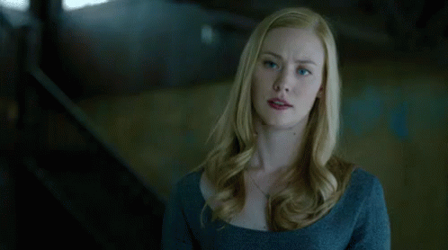 Blue-Eyed Blonde Woman in Blue Sweater and Necklace