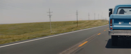 Blue Ford Truck Driving on Highway