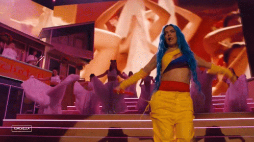 Blue-Haired Woman in Yellow Pants on Stage