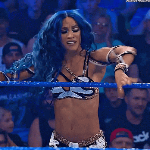 Blue-Haired Woman Raising Hands in Wrestling Ring