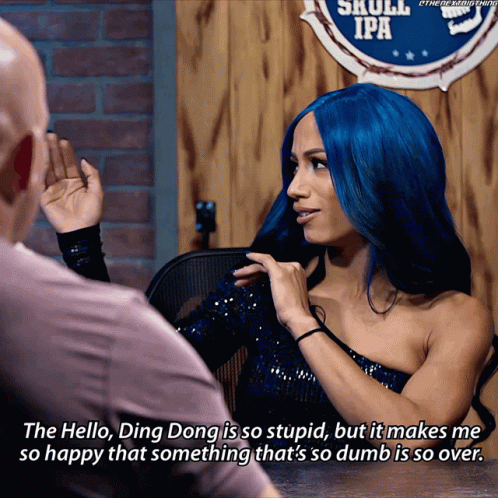 Blue-Haired Woman Talking To Man Near Skull IPA Sign GIF