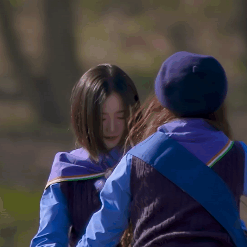 Blue Hat Woman Hugging Blue Vest Woman