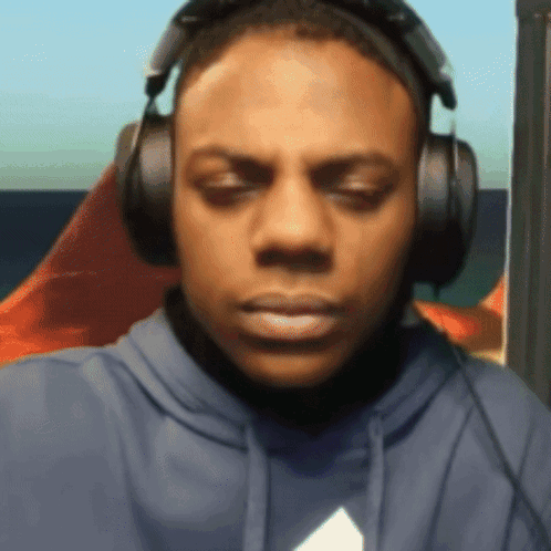 Blue Hoodie Man With Headphones Looking At Camera GIF