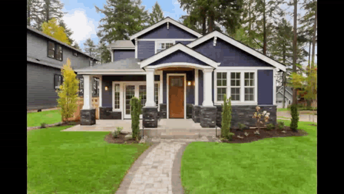 Blue House With White Trim and Brick Walkway