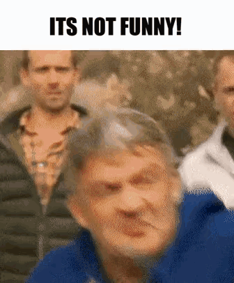 Blue Jacket Man Making Funny Face at Group