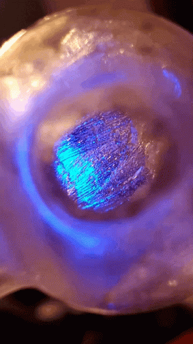 Blue Light Shining on Sphere with Purple Background