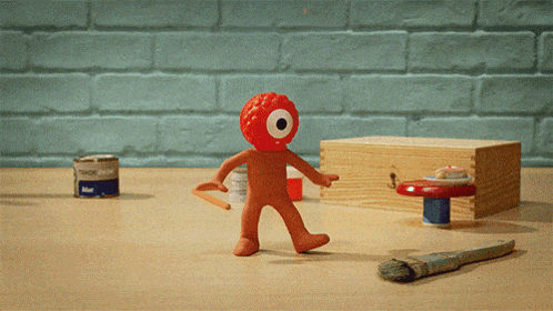 Blue Paint Can Next to Red Toy