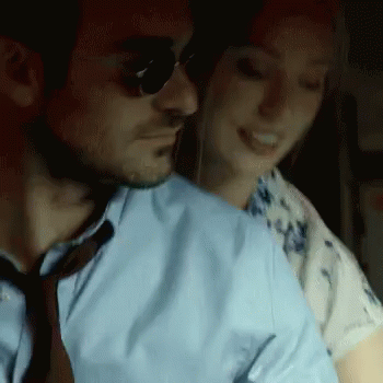 Blue Shirt Man Hugs Woman in White Shirt