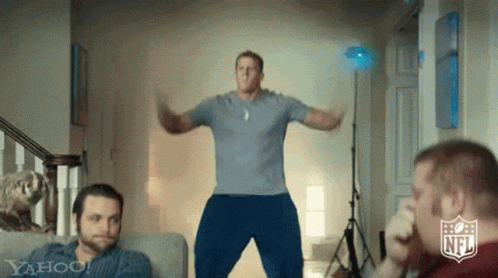 Blue Shirt Man Jumping in Front of Men