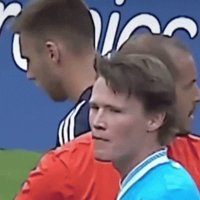 Blue Shirt Man Next to Red Jersey Man