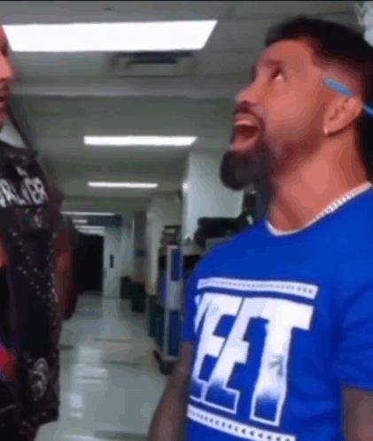 Blue Shirt Man Saying FFT To Another In Hallway GIF
