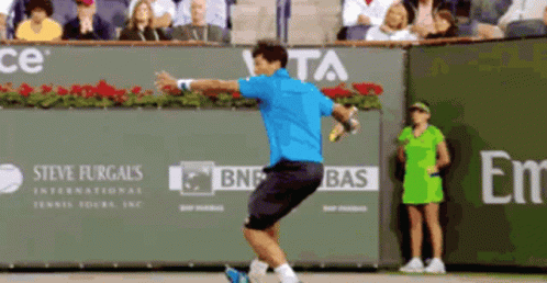 Blue Shirt Man Swinging Tennis Racquet at Steve Furgals Banner