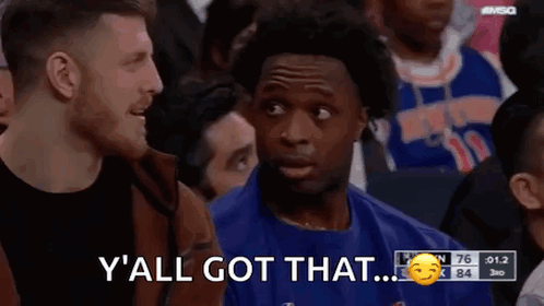 Blue Shirt Man Talking in Crowd Basketball Game