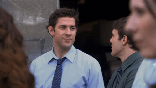Blue Shirt Man with Tie Talking to Green Shirt Man