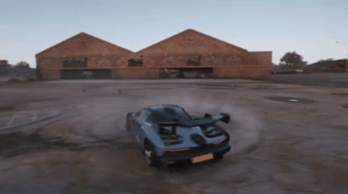 Blue Sports Car Driving on Dirt Road